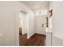 Welcoming entryway with hardwood floors, arched doorway, transom window and stylish light fixture at 3597 Cherbourg Ave, Las Vegas, NV 89141