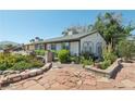 View of a single-story home with brick and stone accents and xeriscaped yard at 4027 Maple Hill Rd, Las Vegas, NV 89115