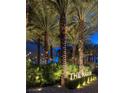 Lush landscaping and palm trees surround the well-lit entrance to The Martin at 4471 Dean Martin Dr # 2406, Las Vegas, NV 89103