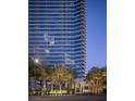 Elegant high-rise exterior with palm trees, lush landscaping, and porte-cochère at 4471 Dean Martin Dr # 2406, Las Vegas, NV 89103
