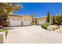 Expansive driveway leads to a three-car garage, showcasing curb appeal and ample parking space at 4493 Rometta Ave, Las Vegas, NV 89141