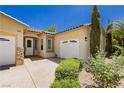 Close up of home and three car garage with desert landscaping at 4493 Rometta Ave, Las Vegas, NV 89141