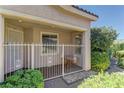 Charming, secure front porch area with decorative metal fence and table, surrounded by green foliage at 4672 Regalo Bello St, Las Vegas, NV 89135