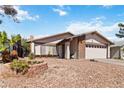 This house features a well-kept desert landscape, flower bed and charming curb appeal at 4775 Woodridge Rd, Las Vegas, NV 89121