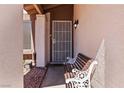 Welcoming front entry with ornate bench seating outside a security door at 4775 Woodridge Rd, Las Vegas, NV 89121