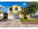Charming two-story home featuring a two-car garage, manicured lawn, and beautiful landscaping at 5907 Soft Mist Ct, Las Vegas, NV 89110