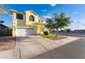 Charming two-story home featuring a two-car garage, manicured lawn, and beautiful landscaping at 5907 Soft Mist Ct, Las Vegas, NV 89110