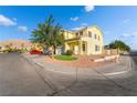 Two-story home featuring a two-car garage, manicured lawn, and rock landscaping at 5907 Soft Mist Ct, Las Vegas, NV 89110