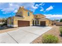 Stunning two-story home with a well-manicured yard and a spacious three car driveway at 5938 Village Loft St, North Las Vegas, NV 89081