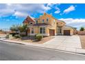 Stunning two-story home with a well-manicured yard and a spacious three car driveway at 5938 Village Loft St, North Las Vegas, NV 89081