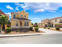 Charming two-story home with a well-maintained front yard and long driveway at 5938 Village Loft St, North Las Vegas, NV 89081