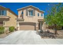 Two-story home featuring a two car garage, neutral color palette, and desert landscaping at 6429 Joshuaville Dr, Las Vegas, NV 89122