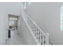 Bright stairway with white railing and tile flooring leading to the upper level at 6429 Joshuaville Dr, Las Vegas, NV 89122