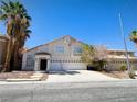 An inviting two-story home with a symmetrical facade and an attached two-car garage at 6608 Buried Treasure Ct, Las Vegas, NV 89139