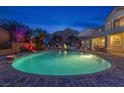 Lush landscaping surrounds a backyard pool and patio area, perfect for outdoor entertaining at 6958 Lazy Sunset Ct, Las Vegas, NV 89156