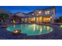 Gorgeous backyard featuring a large in-ground pool, a hot tub, and a spacious patio area at 6958 Lazy Sunset Ct, Las Vegas, NV 89156