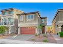 Charming two-story home features a red garage door and manicured landscaping in a well-maintained neighborhood at 7775 Tyrell Peaks St, Las Vegas, NV 89139