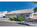Inviting single-story home with a three-car garage and well-maintained front yard at 825 Royal Moon Ave, Las Vegas, NV 89123