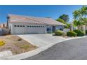 Single-story house with a spacious driveway and desert landscaping at 825 Royal Moon Ave, Las Vegas, NV 89123
