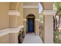 Inviting front entrance featuring a secure door, desert landscaping and a covered porch at 8656 Rowland Bluff Ave, Las Vegas, NV 89178