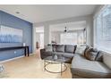Cozy living room with tile floors, a comfortable gray sofa, and ample natural light at 8656 Rowland Bluff Ave, Las Vegas, NV 89178