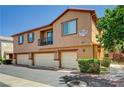 Exterior view of a beautiful townhouse with a small balcony and three garage doors at 9115 Canoga Canyon Ct # 103, Las Vegas, NV 89149