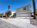 Two-story home with a spacious driveway, two-car garage, and low maintenance front yard at 9693 Bighorn Island Ave, Las Vegas, NV 89148