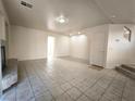 Spacious living room featuring tiled flooring, a fireplace, and neutral wall colors at 9693 Bighorn Island Ave, Las Vegas, NV 89148