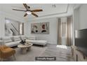 Inviting living room with hardwood floors, white decor, and large flat screen TV at 9784 Kodiak Island Ct, Las Vegas, NV 89141