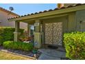 Welcoming front porch with decorative security door, charming potted plants, and well-maintained landscaping at 9909 Masked Duck Ave, Las Vegas, NV 89117