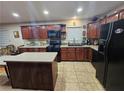 Eat-in kitchen featuring dark wood cabinets, an island, and modern appliances at , Las Vegas, NV 89128