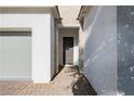 Home front entrance featuring a covered porch and a tiled walkway leading to the front door at , Las Vegas, NV 89166