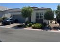 Beautifully landscaped front yard with a charming single-story home featuring a two-car garage at , Las Vegas, NV 89166