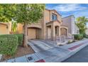 Charming two-story home with front yard, wrought iron gate and an attached garage at 10373 Midnight Iris St, Las Vegas, NV 89183