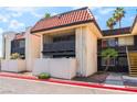 Condo exterior featuring a private balcony, tile roof, and well-maintained landscaping, adding to the curb appeal at 1440 Vegas Valley Dr # 13, Las Vegas, NV 89169