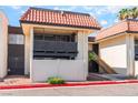 Charming condo exterior with a private balcony, tile roof, and a fenced yard, offering a cozy outdoor space at 1440 Vegas Valley Dr # 13, Las Vegas, NV 89169