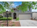 Charming two-story home with a two-car garage, landscaped front yard, inviting porch and red front door at 1553 Ivygate Ave, Las Vegas, NV 89183