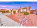 Beautifully landscaped front yard with mature shrubbery, decorative rock stream, and ample street parking at 1643 Silver Slipper Ave, Henderson, NV 89002