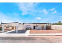 Charming single story home with a covered carport, desert landscaping, and black trimmed windows at 1700 Sweeney Ave, Las Vegas, NV 89104