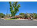 Well-maintained single-story home boasts mature trees, desert landscaping, and a lush lawn in a desirable location at 1705 Westwind Rd, Las Vegas, NV 89146