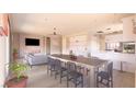 Open-concept living space featuring fireplace, dining area, and modern kitchen with stainless appliances at 1840 Old West Ave, Pahrump, NV 89048