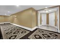 Hallway with decorative carpet design leading to a condo entrance with double doors at 2000 N Fashion Show Dr # 2222, Las Vegas, NV 89109