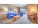 Cozy living room with comfortable seating, balcony access, and city views at 211 E Flamingo Rd # 402, Las Vegas, NV 89169