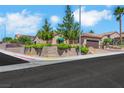 Street view showing a well-maintained home with desert landscaping and a retaining wall at 2166 Alyssa Jade Dr, Henderson, NV 89052