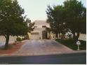 View of the large home featuring a circular driveway and well-manicured lawn at 3142 Bel Air Dr, Las Vegas, NV 89109