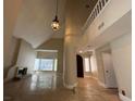 Open concept living room with high ceilings and large windows with a fireplace at 3142 Bel Air Dr, Las Vegas, NV 89109