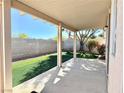 Relaxing covered back patio overlooking a well-kept lawn and block wall for privacy at 338 Brilliant Summit Cir, Henderson, NV 89052