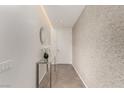 Bright hallway featuring sleek tile flooring, contemporary decor, and minimalist design elements with textured wall at 3722 Las Vegas Blvd # 3209, Las Vegas, NV 89158