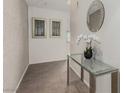 Elegant hallway featuring a glass console table, decorative mirror, and textured wall for a sophisticated entrance at 3722 Las Vegas Blvd # 3209, Las Vegas, NV 89158