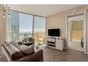 Modern living room featuring stylish furnishings, sleek entertainment center, and panoramic city views through expansive windows at 3722 Las Vegas Blvd # 3209, Las Vegas, NV 89158